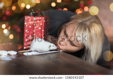 woman kissing her pet white rat new year 2020 symbol