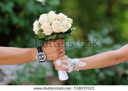 groom gives the bride a bouquet of roses