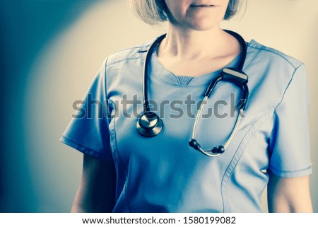 Closeup on a mature nurse with stethoscope