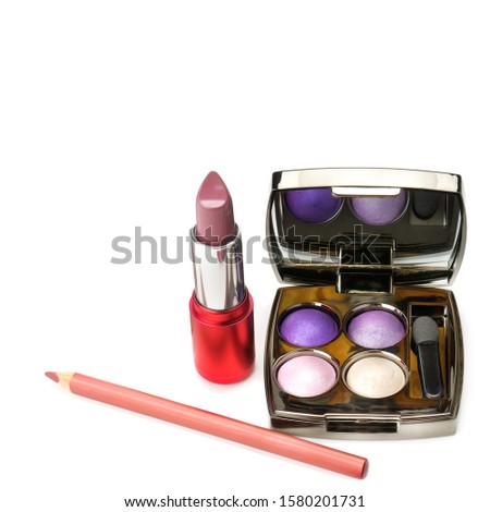 Set of lipstick and eye shadow isolated on white background. There is free space for your text.