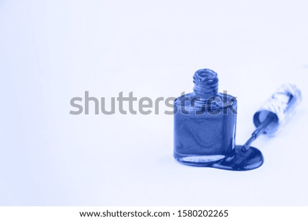 Nail polishes in classic blue color. Trendy mood. Beauty concept.