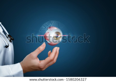 Concept check a patient eye. Doctor shows scanning eyes on a blue background. Royalty-Free Stock Photo #1580206327