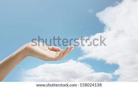 hand in sky holding something