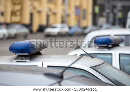 parked police cars with the flashing light turned off