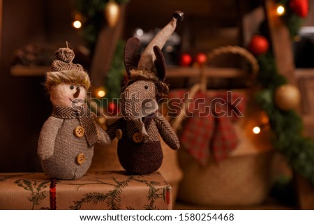 Beautiful Christmas composition with vintage decoration. Snowman and Christmas deer toys. Blurred sparkling background and copy space. Magic Holiday