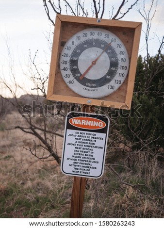 Sign and thermometer warning of hot temperatures and heat exhaustion in a Texas State Park. Palo Duro Canyon hiking.
