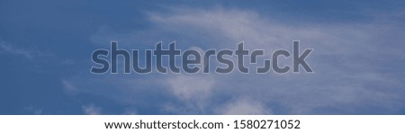 daytime sky landscape with white clouds and moon