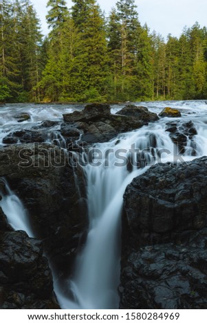 Long exposure of river and waterfalls in remote nature in summer