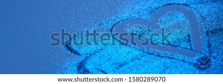 Modern shiny background with heart, trend color of the year 2020 classic blue. Glitter blue