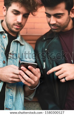Young people interacting with a mobile phone