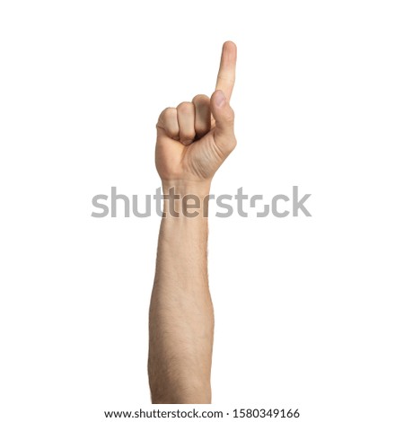 Adult man hand showing finger pointing gesture with forefinger. Human hand gesturing sign isolated on white background studio shot. Male raised arm presenting popular gesture.