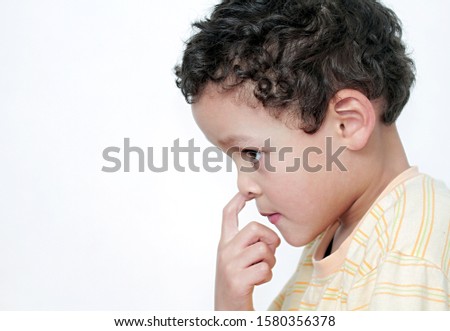 boy picking his nose and having fun with white background stock photo