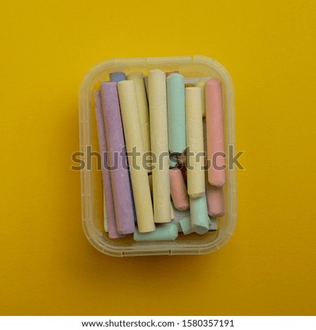 Color pencils isolated on yellow background to mean a concept