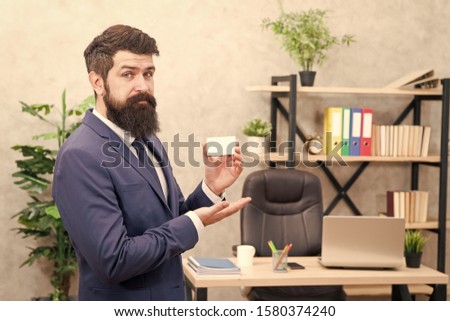 Businessman hold blank card. Useful contacts. Bearded hipster top manager show card. Banking services. Private lawyer. Call me if you have any questions. Card design. Guy formal suit stand in office.