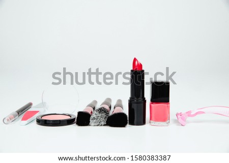 Set of woman make up cosmetics on white background. Beauty and fashion concept. On table lies lipstick, eye pencil, eye shadow, brushes. Fashionable Women's Cosmetics and Accessories.