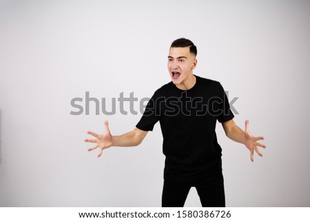 A man screams and shows his palms on a white background