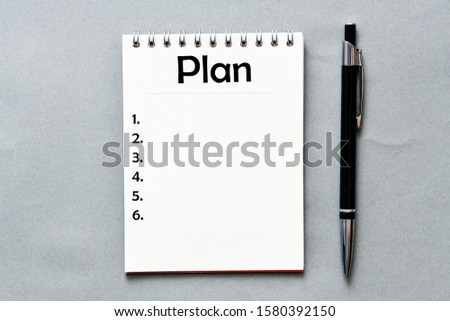 Plan text in notebook on gray background. View from above. High resolution photography - business concept.