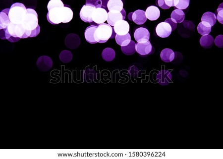 Abstract background purple bokeh with black background.