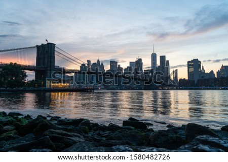 New York City Skyline At Sunset From Brooklyn Bridge Park Looking Toward Lower Manhattan And The One World Trade Center.