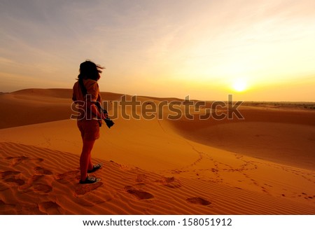 Girl Photographer in Sunrise Desert 