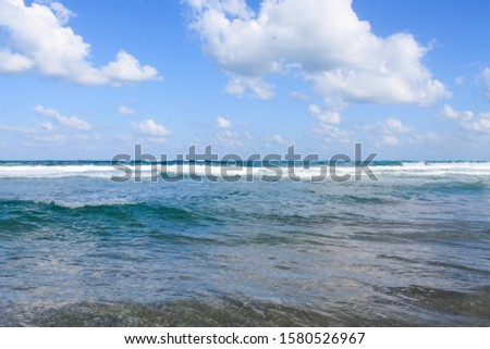 Seashore at Bat Yam, Israel. Waves on the blue stormy sea. Mediterranean coastline. Travelling picture. Turquoise water and sandy beach