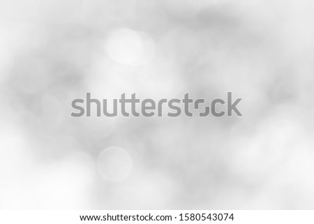 [object Object]Gray and white nature blurred color glow colorful light sparkling summer. Valentine's day blurry concept. Abstract white bokeh texture with soft foreground bubble shiny in grey vintage 