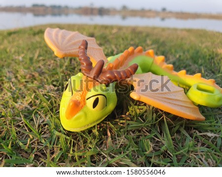A dragon toy with green background