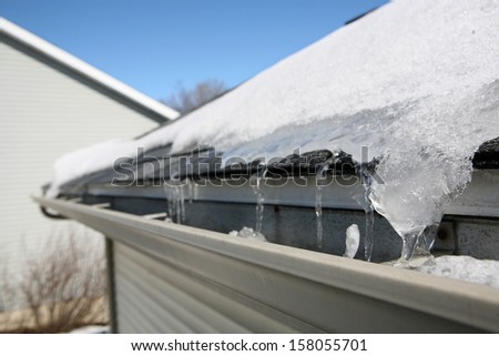 Ice on roof and gutters Royalty-Free Stock Photo #158055701