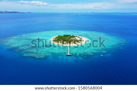 Paradise Island. Aerial View of beautiful Mala Mala Island, Fiji, Pacific Ocean. Drone shot. Royalty-Free Stock Photo #1580568004