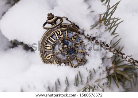 
Antique clocks lie on the snow before the new year. New Years Eve 2020.