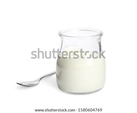Tasty organic yogurt in glass jar and spoon isolated on white