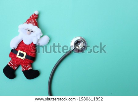 stethoscope and Santa Claus on green background. Christmas and New Year