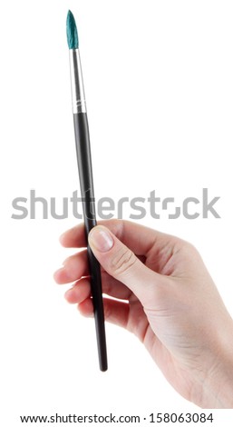 Hand holding brush with green paint isolated on white