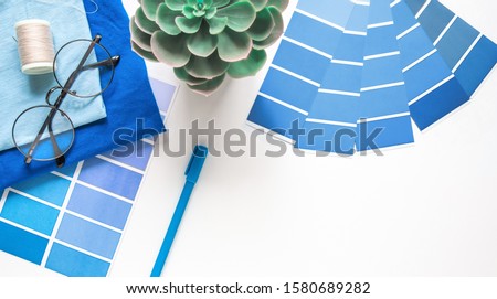designer , seamstress desktop. Color sample guide blue. Color of the year 2020 pantone classic blue