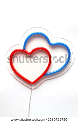 Red and blue heart in one neon sign on white background.  Neon concept. Modern style. Neon sign.
