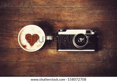 Cup of coffee with retro camera