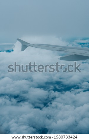 Amazing Shot of Sea of Clouds and Blue Sky as seen through the Window of a Famous Aircraft or Airbus over Manila, Philippines, Asia in Friday Morning Flight for relax in Holiday Vacation