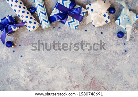 Christmas background. Christmas gift wrapping in blue. Christmas time celebration. Top view or flat lay. Space for text.