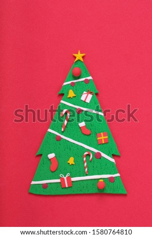 a handmade clay sculpture Christmas tree with ornaments