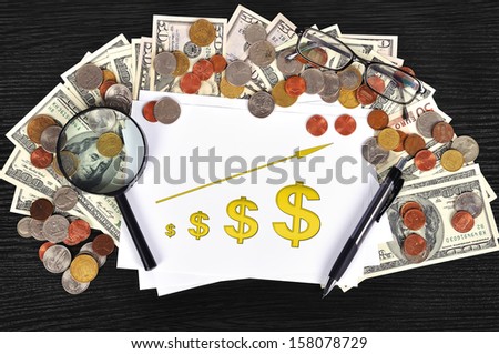 money on table and paper with chart