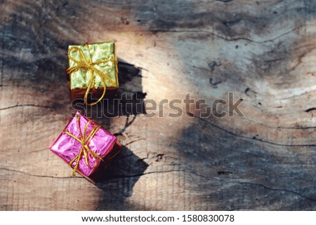 Close up small gift box on old wood table, copy space background for text, merry christmas and happy new year, holiday season concept