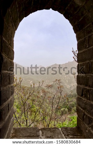 The Great Wall of China in summer. The Mutianyu area. China famous landmark. wonders of the world. landscape view through the tower window
