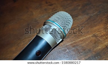 the texture of the microphone head against a dark background