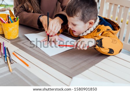 mother and son draw drawing hands colored pencils