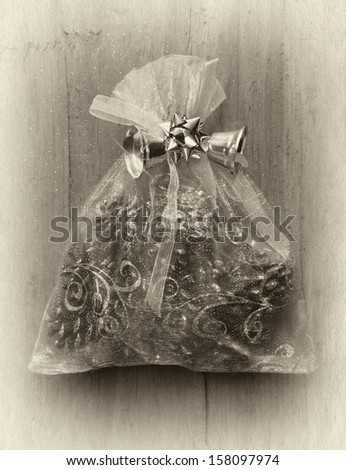 Christmas bag with gifts on wooden wall, retro illustration