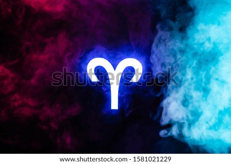 blue illuminated Aries zodiac sign with colorful smoke on background