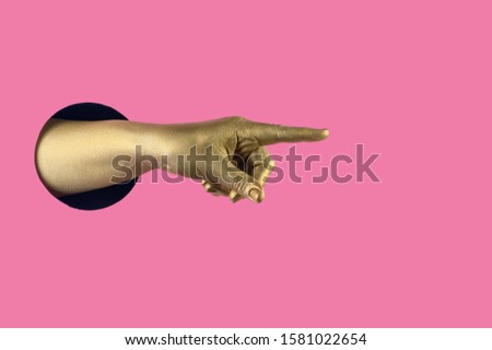 Hand painted in gold shows different gestures and symbols from the hole on a pink pastel paper background. Creative template for design. 
