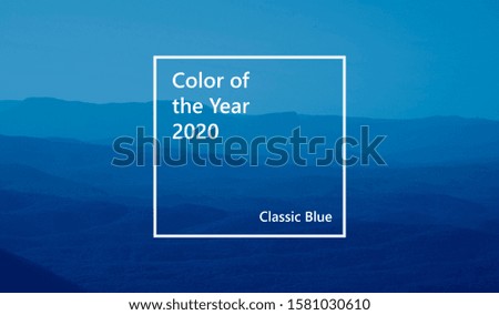 low mountains in mist colored toned in trendy Classic Blue pantone color of the year 2020