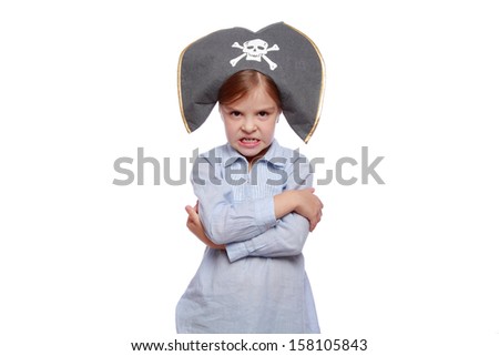 Studio image of a charming emotional little girl with a sweet smile as evil pirate in a pirate hat isolated on white on Holiday