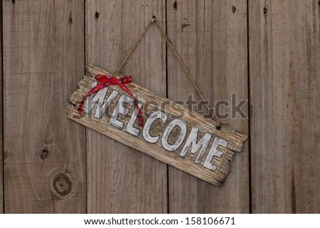 Welcome sign on wooden fence